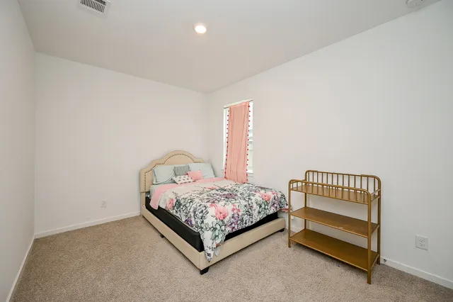 a bedroom with a bed and a dresser