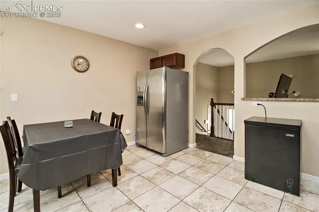 a view of kitchen with stainless steel appliances granite countertop a refrigerator and a sink