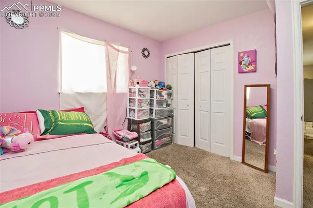 a bed room with a bed and a window