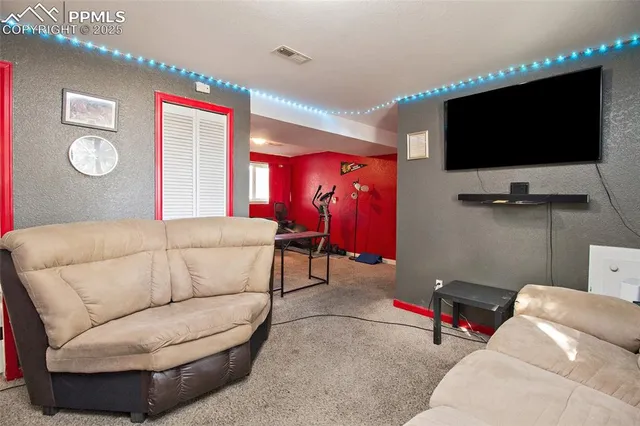 a living room with furniture and a flat screen tv