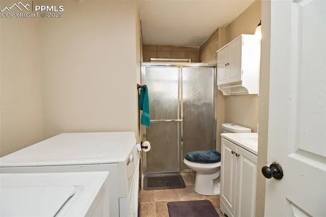 a en suite bathroom with a granite countertop sink and a mirror