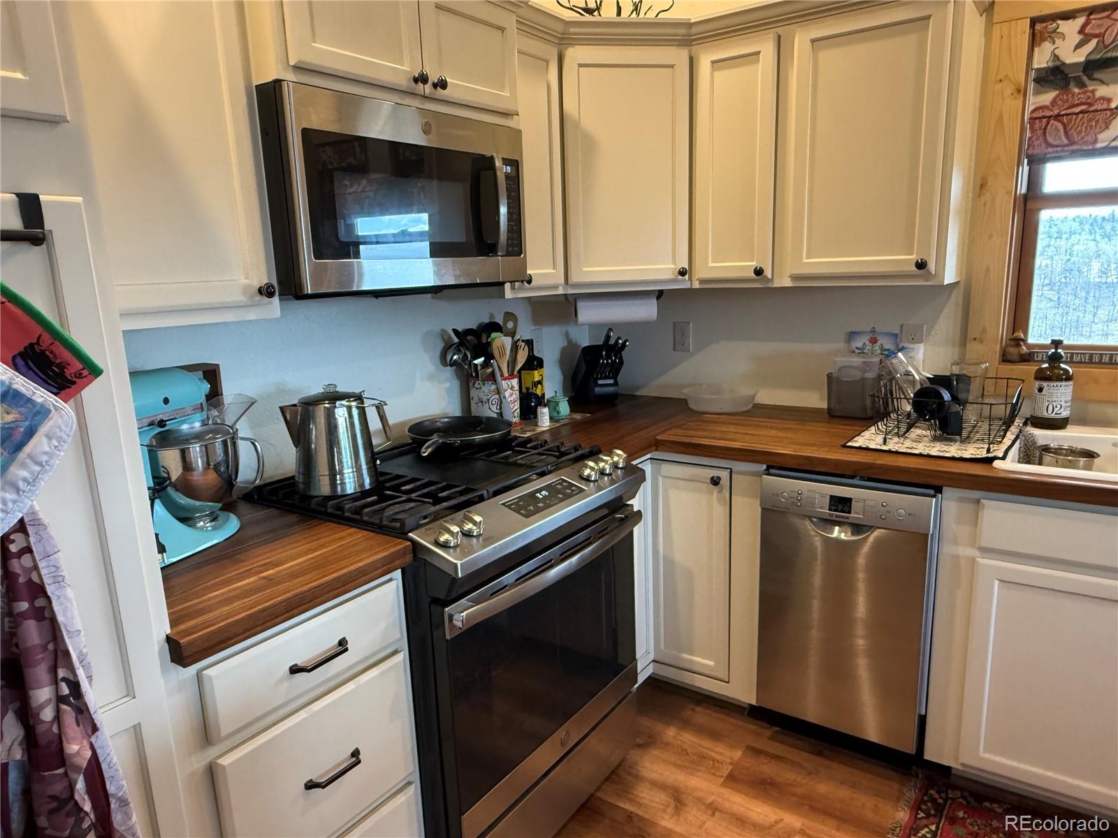 406-449 Schierl Road Fort Garland, CO 81133 - Photo 15 of 50 a kitchen with stainless steel appliances granite countertop a stove a microwave and cabinets