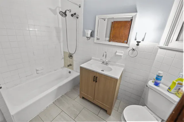 a bathroom with a sink mirror vanity and toilet