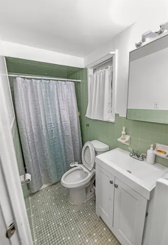 a bathroom with a sink toilet and window