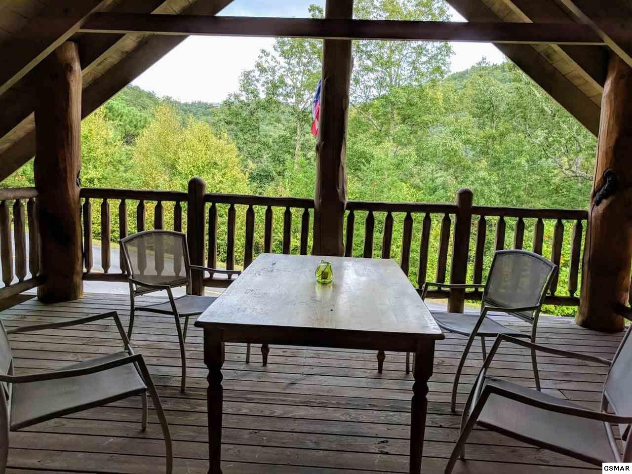 4409 Deerskin Road Sevierville, TN 37862 - Photo 10 of 31 a view of a balcony with chairs and wooden floor