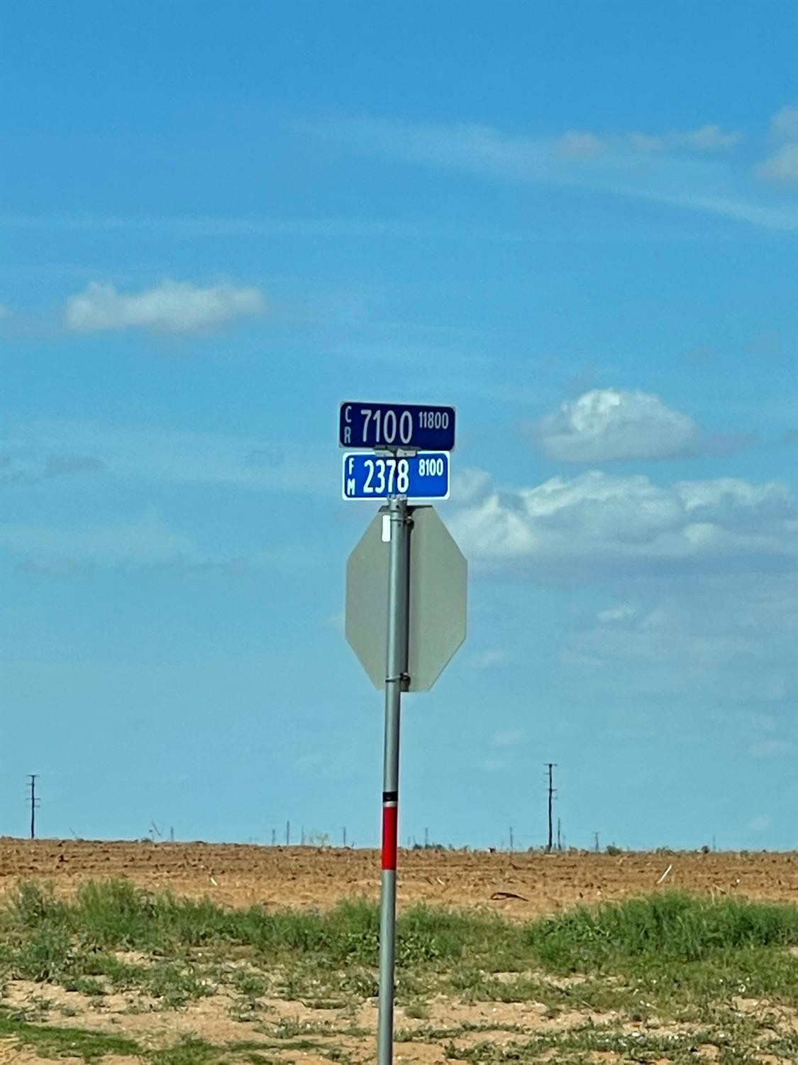 6 Quail Road Lubbock, TX 79407 - Photo 3 of 6 a sign that is on a pole next to a road