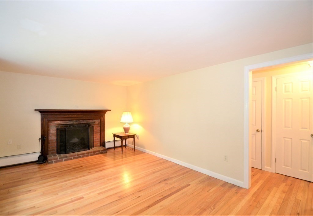95 Pine Hill Road Ashland, MA 01721 - Photo 14 of 30 a view of a livingroom with wooden floor and a fireplace