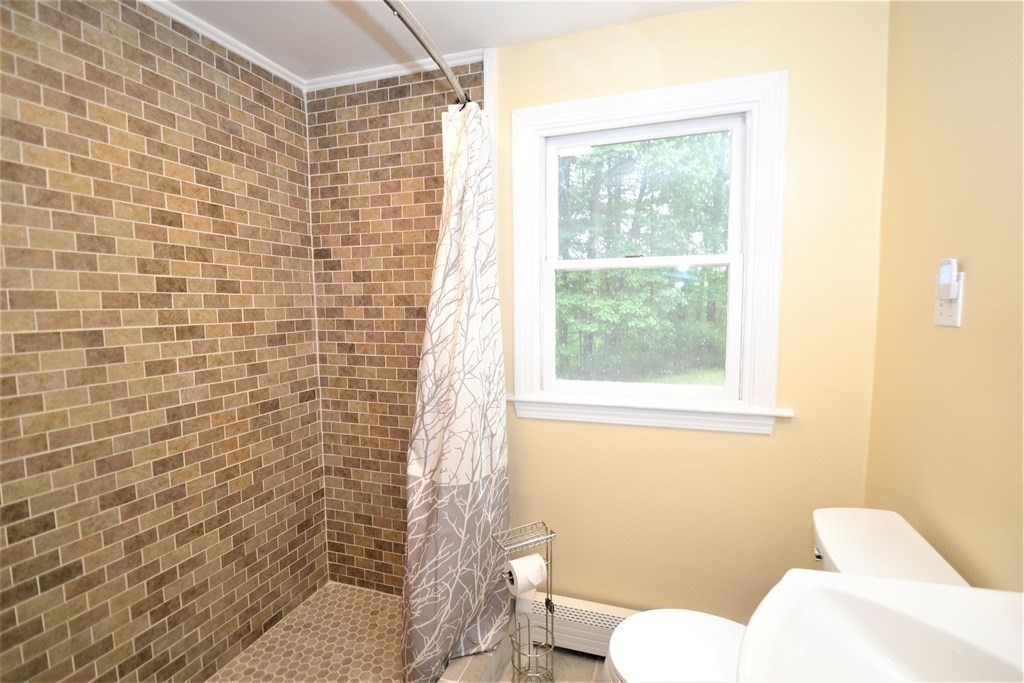 95 Pine Hill Road Ashland, MA 01721 - Photo 17 of 30 a bathroom with a toilet sink and shower