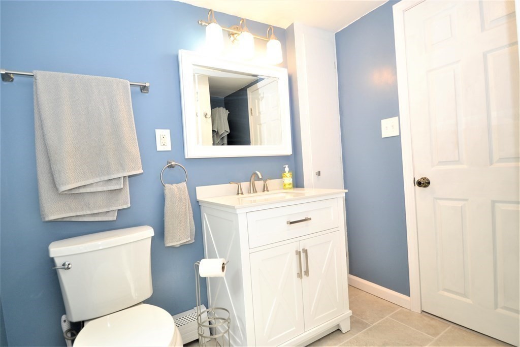 95 Pine Hill Road Ashland, MA 01721 - Photo 22 of 30 a bathroom with a toilet sink vanity and mirror