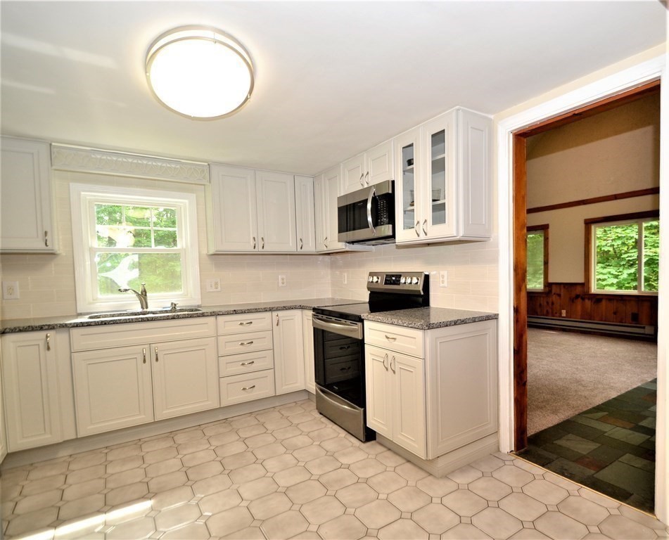 95 Pine Hill Road Ashland, MA 01721 - Photo 3 of 30 a kitchen with cabinets appliances and a window