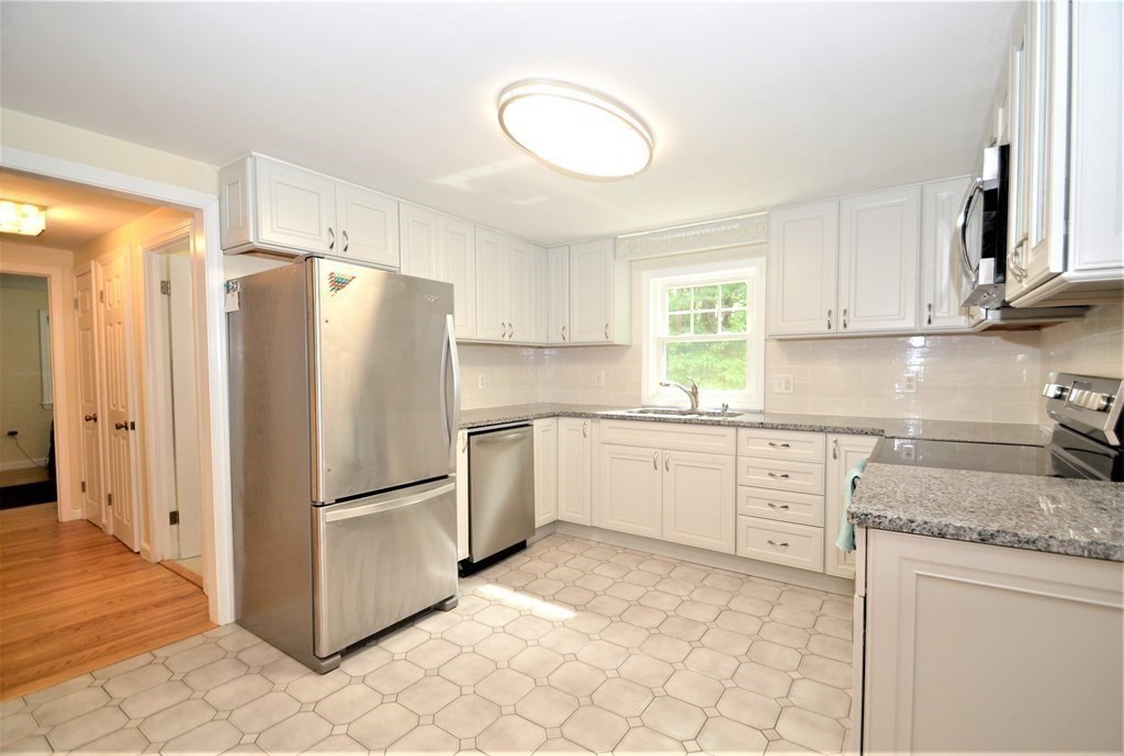 95 Pine Hill Road Ashland, MA 01721 - Photo 4 of 30 a kitchen with granite countertop cabinets and a refrigerator