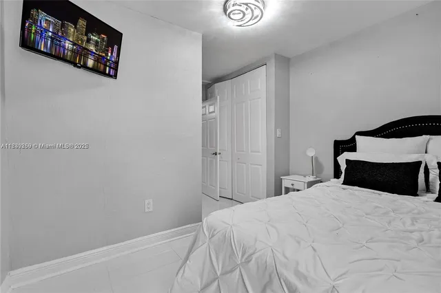 a bedroom with a bed and a wall painting