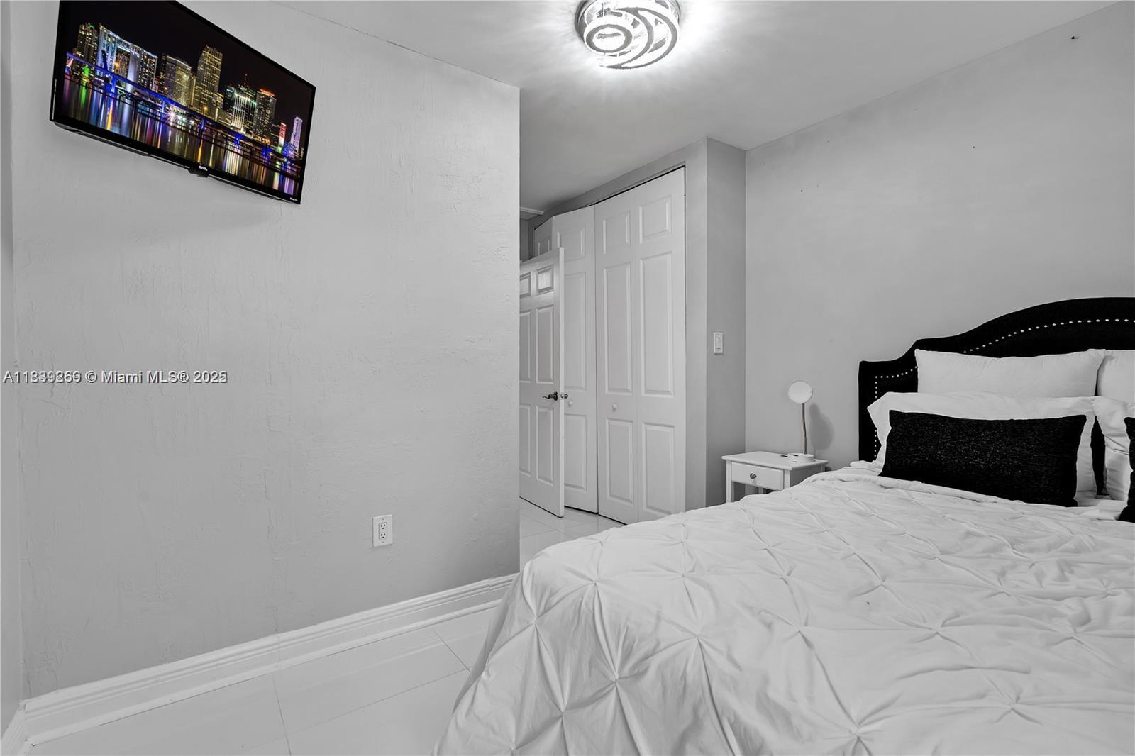 1761 Southwest 14th Street Miami, FL 33145 - Photo 11 of 37 a bedroom with a bed and a wall painting
