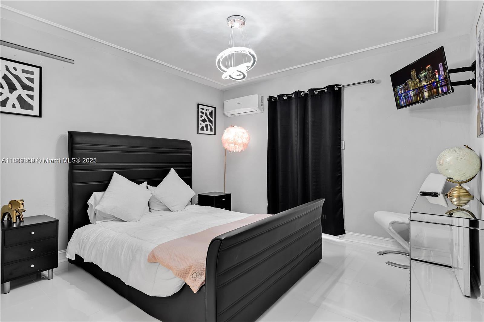 1761 Southwest 14th Street Miami, FL 33145 - Photo 16 of 37 a bedroom with a bed and a chair