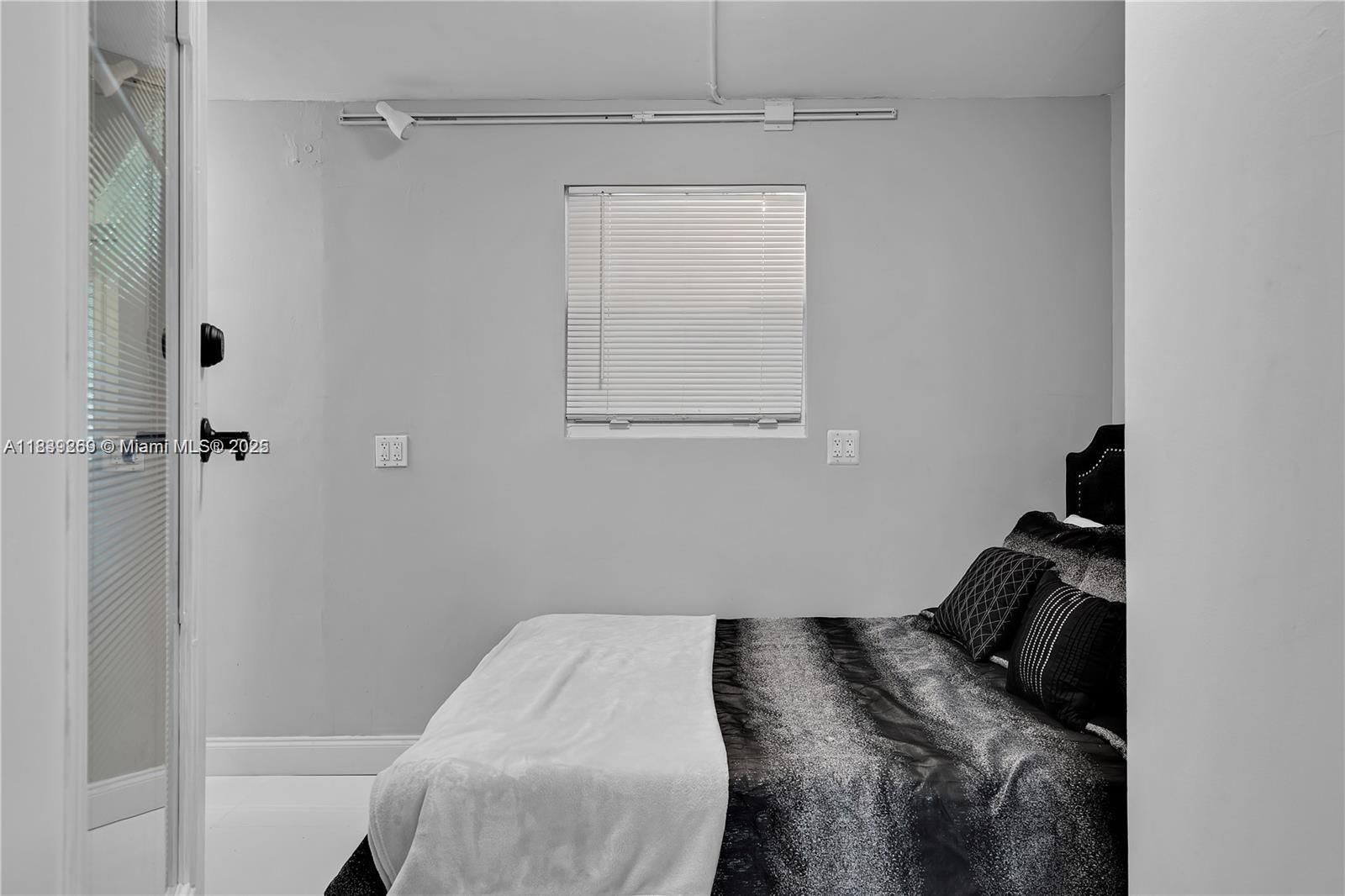 1761 Southwest 14th Street Miami, FL 33145 - Photo 23 of 37 a bedroom with a bed and a window