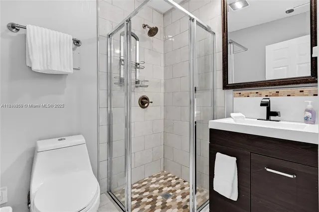 a bathroom with a sink toilet and shower