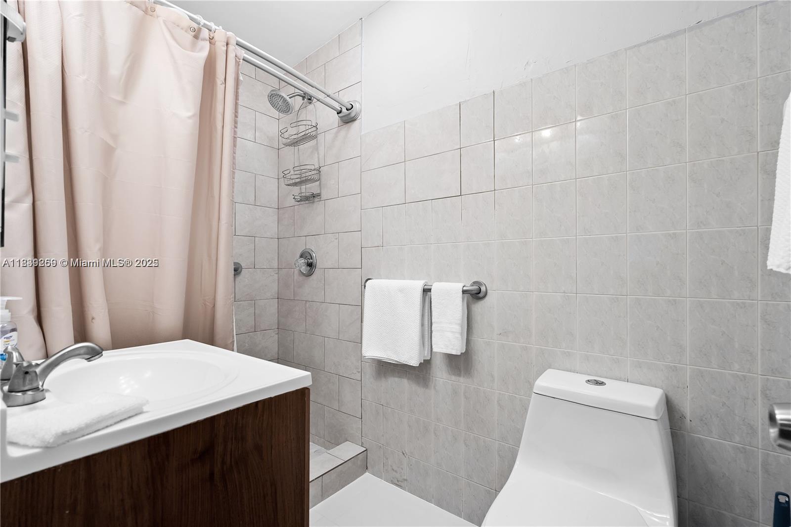 1761 Southwest 14th Street Miami, FL 33145 - Photo 28 of 37 a bathroom with a sink a toilet and shower