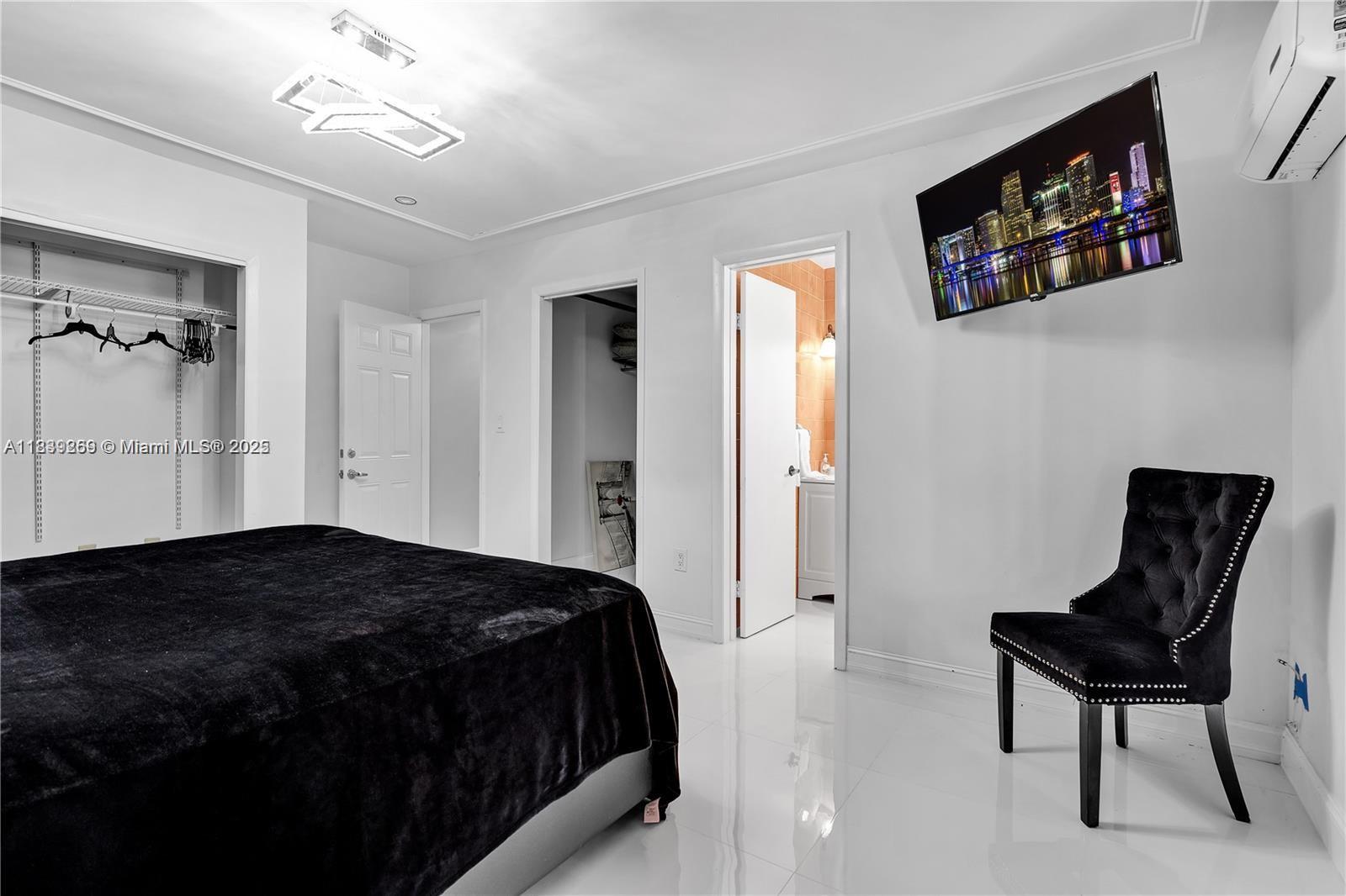 1761 Southwest 14th Street Miami, FL 33145 - Photo 34 of 37 a bedroom with a bed and a chair