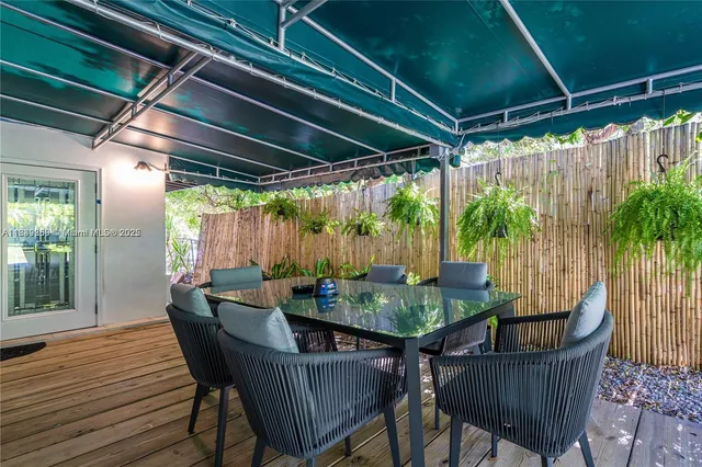 a view of outdoor sitting area with furniture and wooden floor