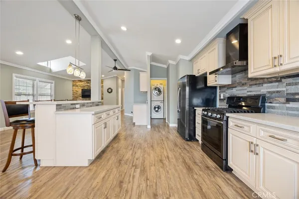 a large kitchen with stainless steel appliances and white cabinets