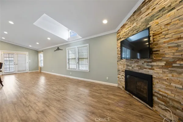 a view of empty room with wooden floor and fireplace