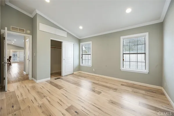 a view of empty room with wooden floor