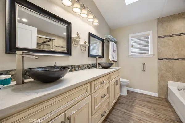a bathroom with a sink a mirror and a toilet