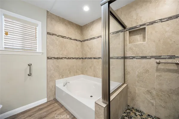 a bathroom with a bathtub and shower