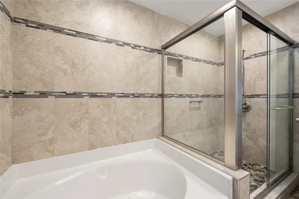 a bathroom with a shower and a glass door