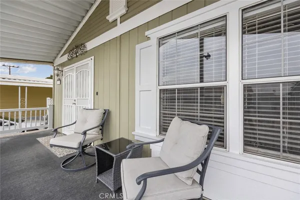 a view of a porch with a table and chairs