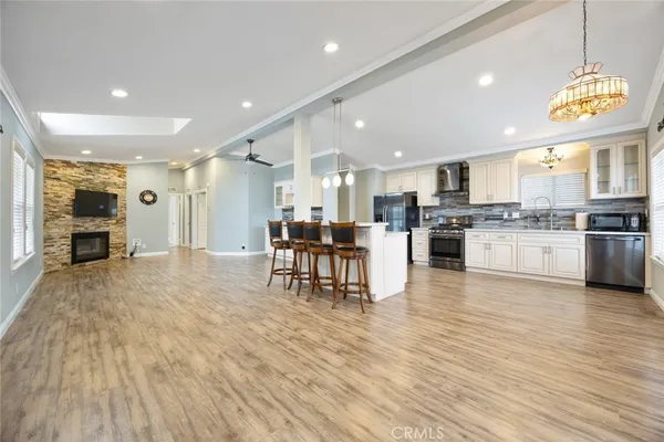 a large kitchen with stainless steel appliances granite countertop a stove and a refrigerator