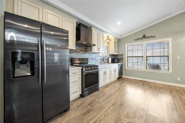 a kitchen with stainless steel appliances a refrigerator sink and cabinets