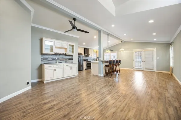 a view of a kitchen with cabinets and wooden floor
