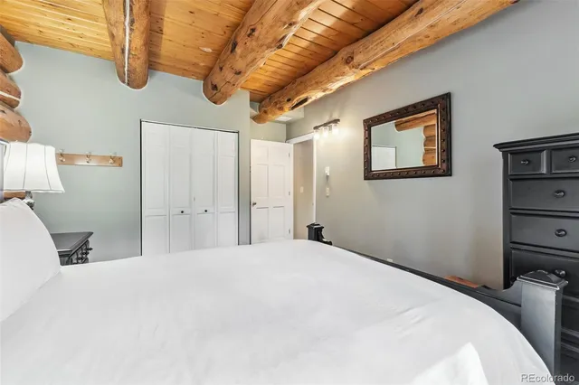 a bedroom with a bed and a painting on the wall