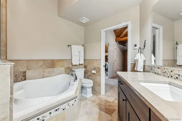 a bath tub sitting next to a white sink