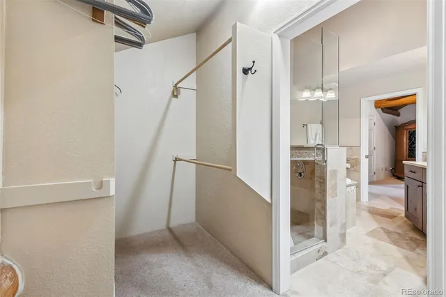 a view of a hallway with wooden floor and entryway