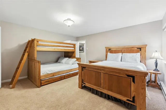 a bedroom with a bed and a night stand