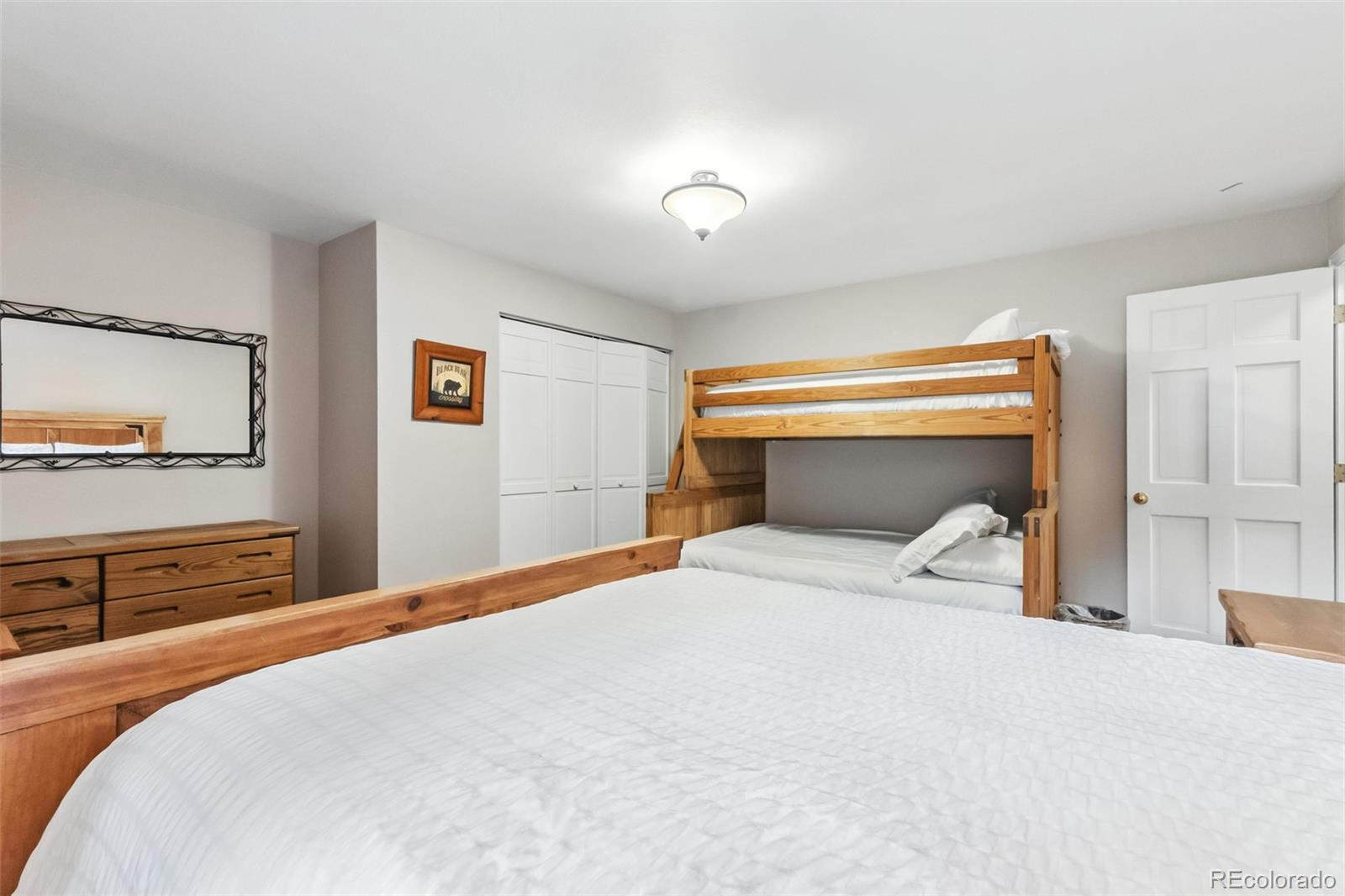 46 Indiana Creek Road Breckenridge, CO 80424 - Photo 35 of 50 a bedroom with a bed and a large mirror