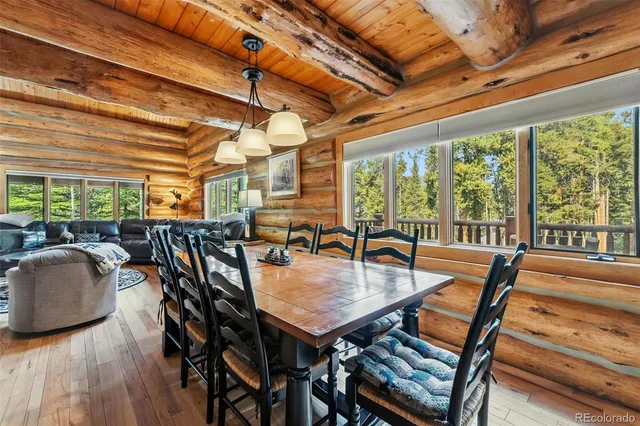 a dining room with furniture and wooden floor