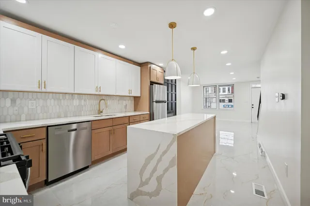 a bathroom with a toilet a sink a mirror a bathtub and vanity