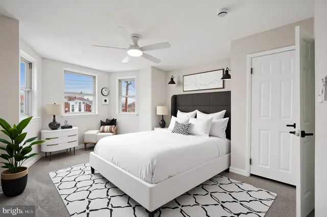 an empty room with fan and windows