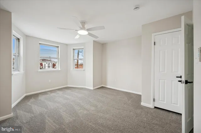 a view of an empty room with windows