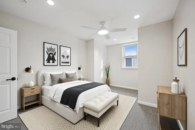 an empty room with a fan & a window