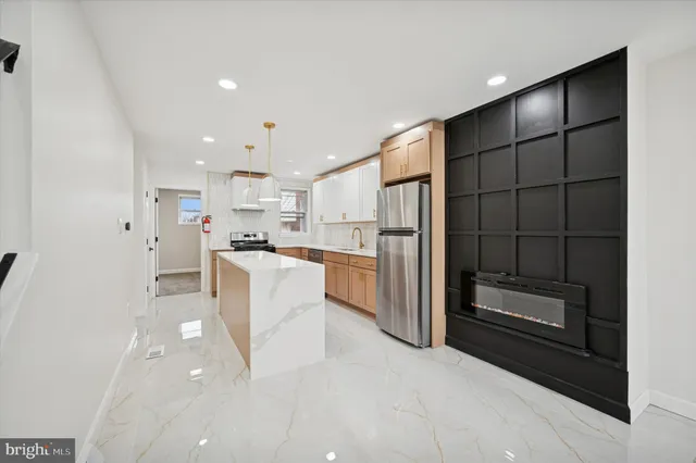 a kitchen with white cabinets and refrigerator