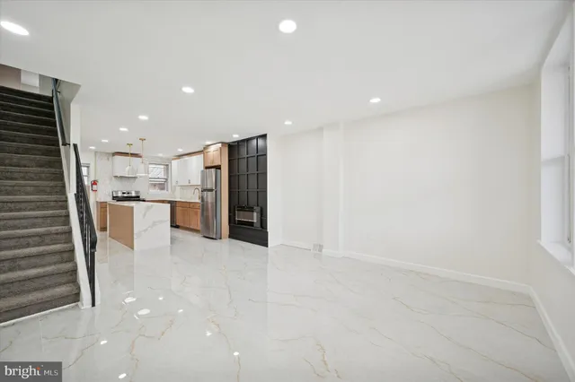 a view of kitchen with refrigerator and window