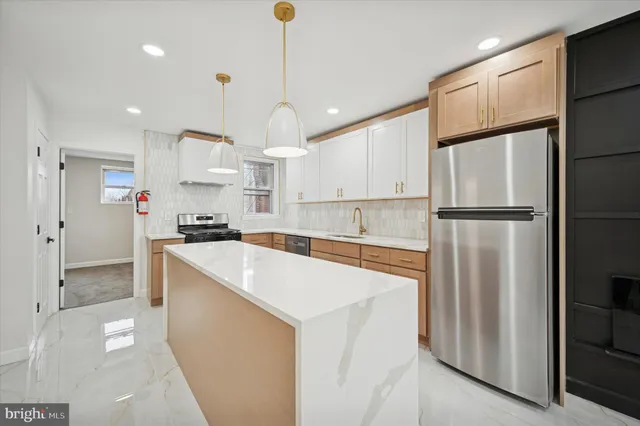 a kitchen with a sink refrigerator and microwave