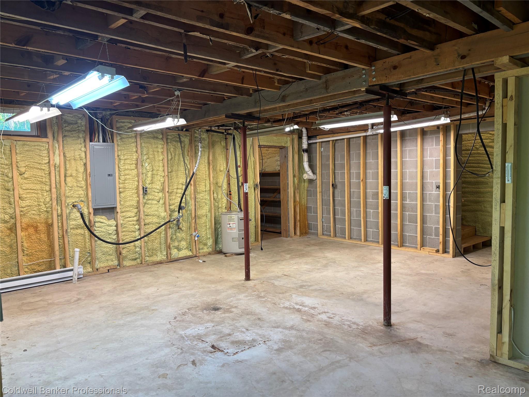 11560 Ashman Hl Road Boyne Falls, MI 49713 - Photo 10 of 22 Spacious unfinished basement featuring exposed ceiling joists, concrete flooring, and spray foam insulation