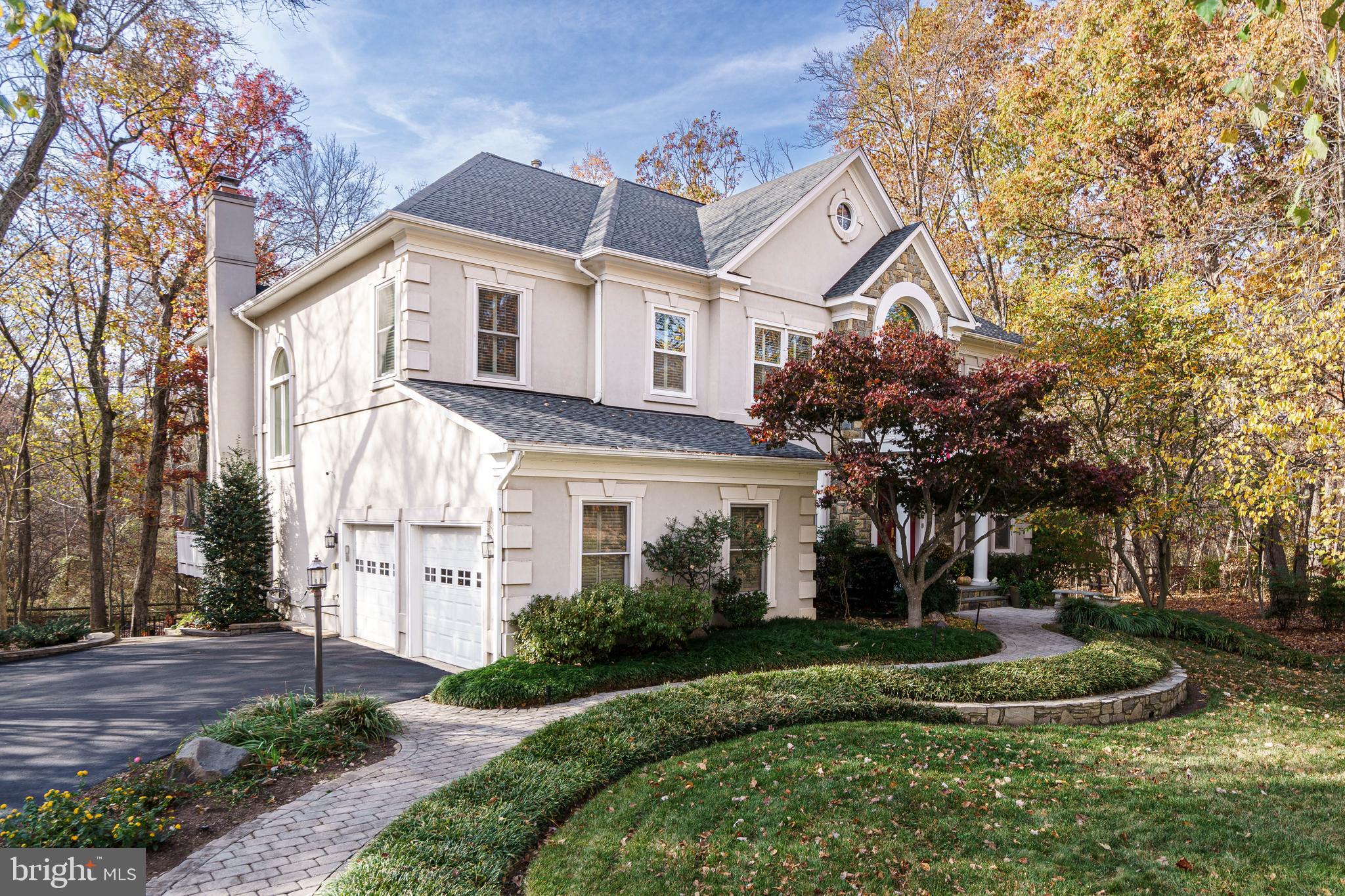 12106 North Walnut Branch Road Reston, VA 20194 - Photo 3 of 57 a view of a white house next to a yard with big trees