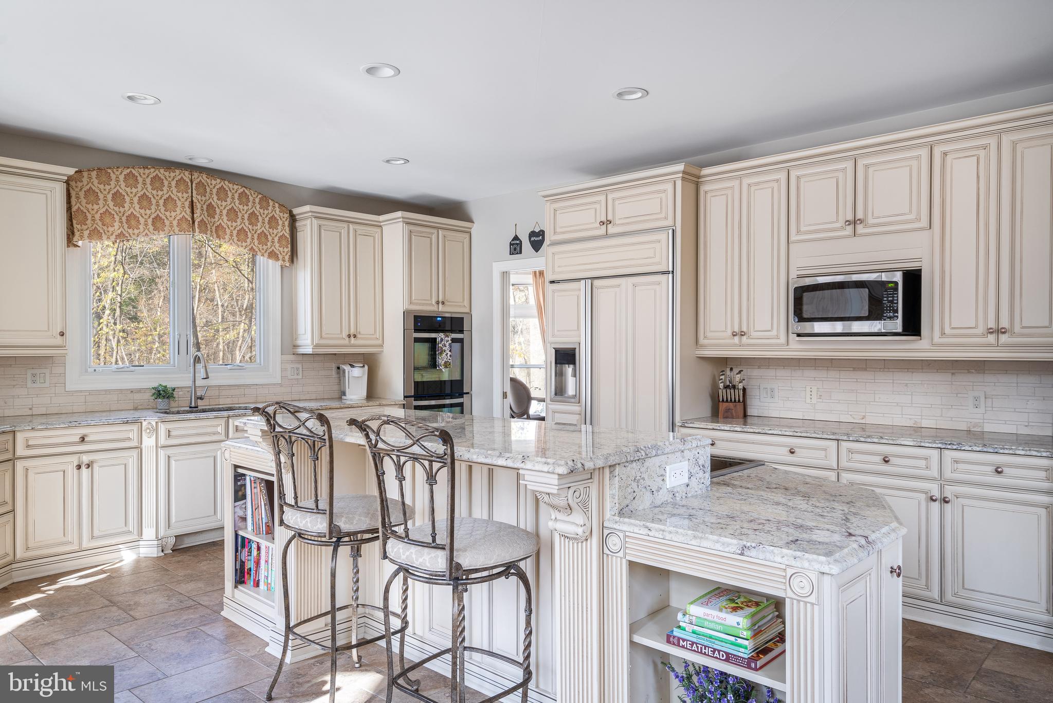 12106 North Walnut Branch Road Reston, VA 20194 - Photo 5 of 57 a kitchen with stainless steel appliances kitchen island granite countertop a stove a sink and a microwave
