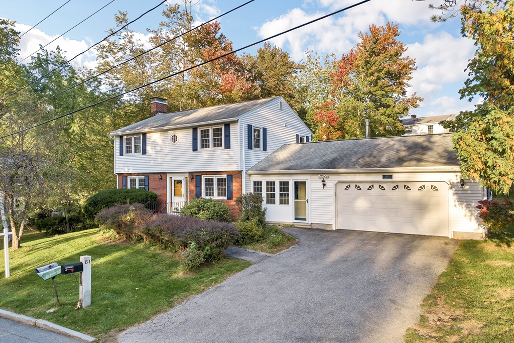 81 Magnolia Road Manchester, NH 03104 - Photo 1 of 35 a front view of house with yard and trees in the background